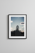 Ferris wheel silhouette fine art print in a black frame on a grey wall, studio mockup
