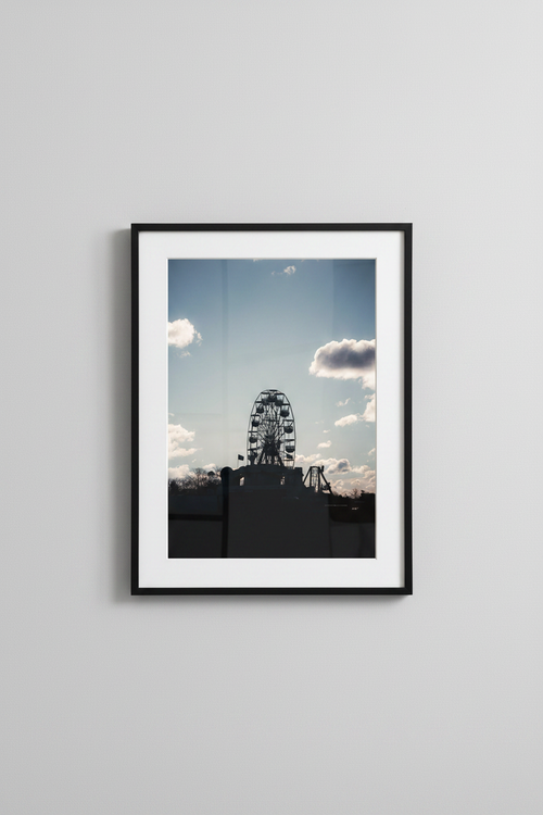 Ferris wheel silhouette fine art print in a black frame on a grey wall, studio mockup